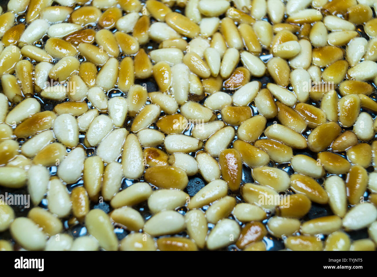 roasted pine nuts for a green pesto Stock Photo Alamy
