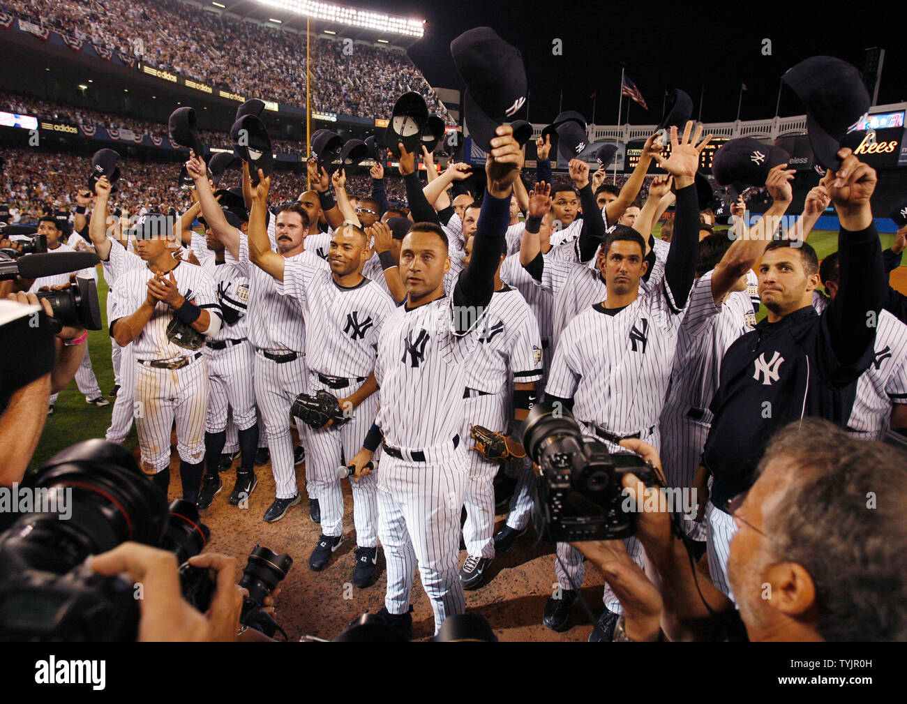 Derek Jeter and the entire New York Yankees team tip their hats to the fans  after the game against the Baltimore Orioles in the final game ever at Yankee  Stadium in New