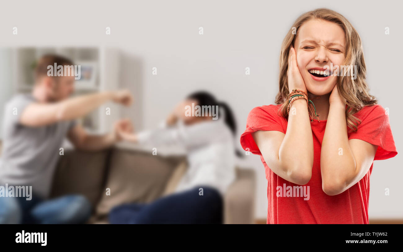 girl covering ears over her parents having fight Stock Photo