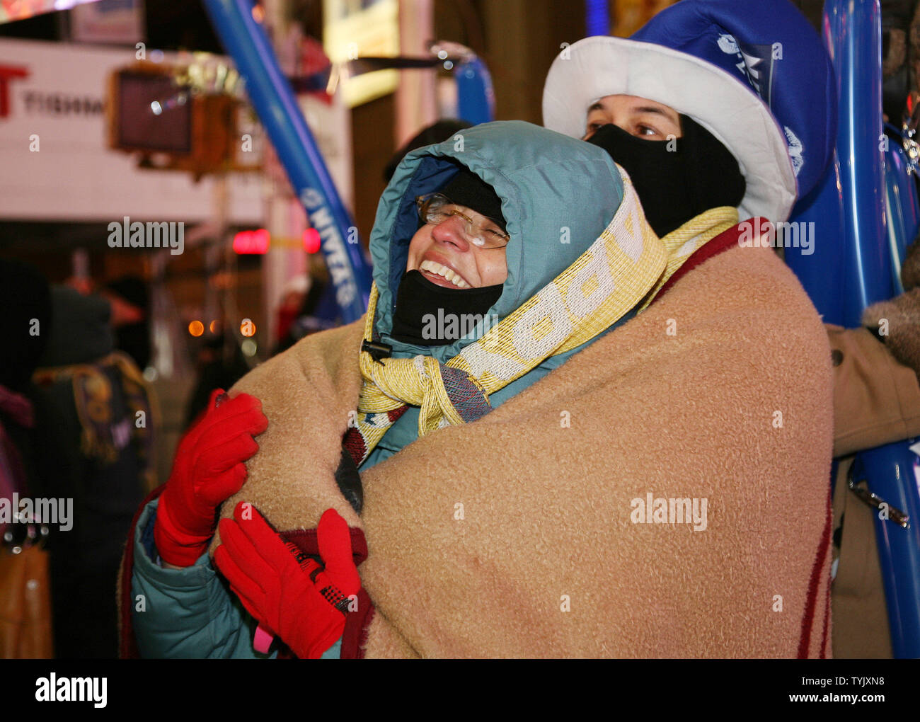Betty and Lee Plevney of San Francisco huddle to keep warm as they join the thousands of  of revelers gathered in Times Square in sub-freezing temperatures as they celebrate New Year's Eve on December 31, 2008 in New York City. (UPI Photo/Monika Graff) Stock Photo