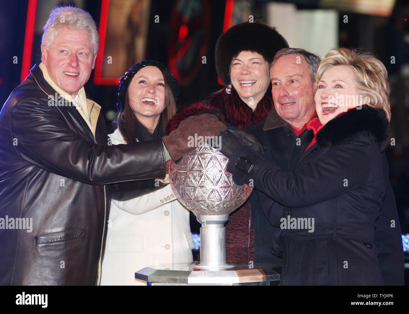 Former President Bill Clinton (L), Emma Bloomberg, second left, Diane Taylor, center, New York City Mayor Michael Bloomberg and U.S. Senator Hillary Rodham Clinton (D-NY)  push the button which starts the decent of the New Year's eve crystal ball just before midnight in Times Square during the New Year's Eve celebration on December 31, 2008 in New York City. (UPI Photo/Monika Graff) Stock Photo