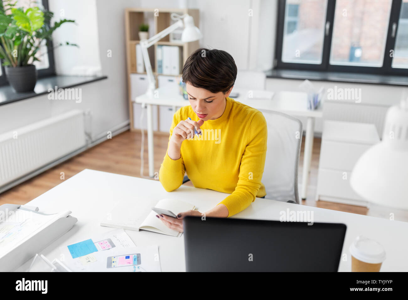 ui designer using smartphoneat office Stock Photo