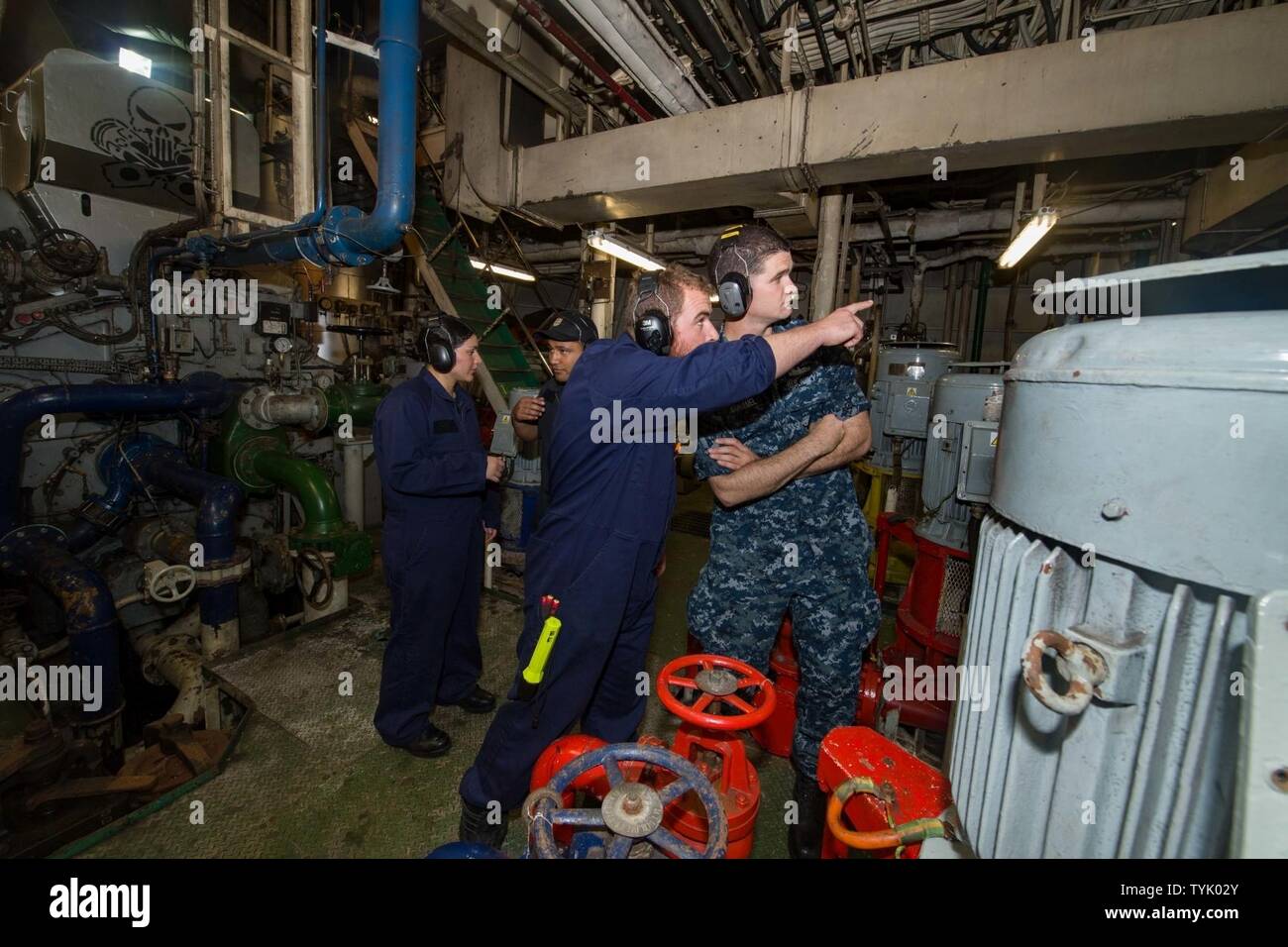 OCEAN (Nov. 12, 2016) – Arleigh Burke-class guided-missile destroyer USS Sampson (DDG 102) sailors Ens. Marianne Estrada, from Las Vegas, Nev., left, and Petty officer 3rd Class Brian Duhamel, from Palm Harbor, Fla., right, receive a tour of the ship engine space from Royal New Zealand Navy Sailors aboard Her Majesty’s New Zealand Ship Endeavour. Sampson will report to U.S. Third Fleet, headquartered in San Diego, while deployed to the Western Pacific as part of the U.S. Pacific Fleet-led initiative to extend the command and control functions of Third Fleet into the region. Stock Photo