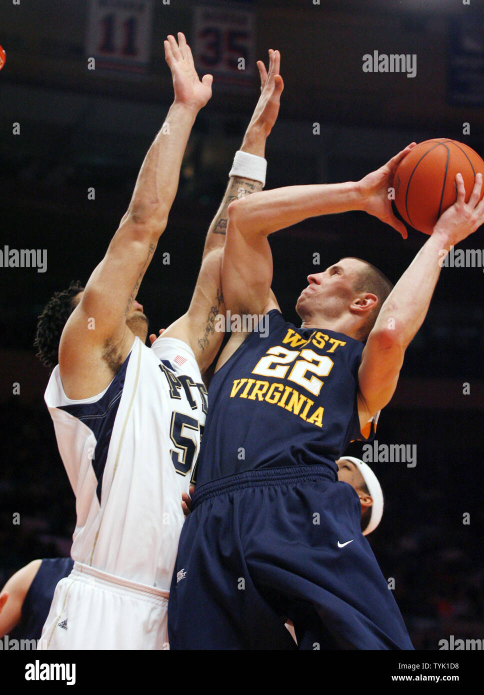 West Virginia Mountaineers Alex Ruoff (22) leaps under the basket in