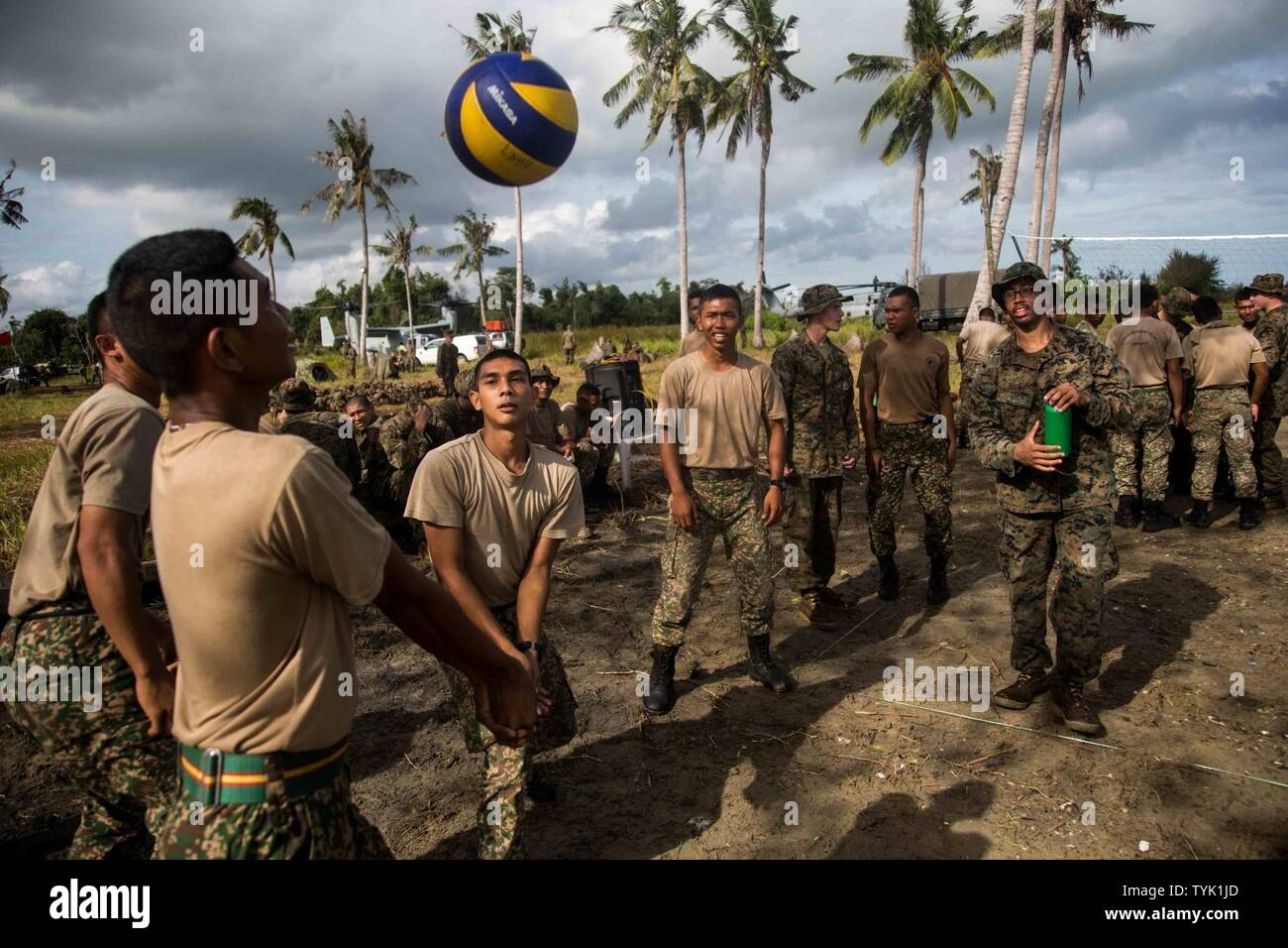 SABAH PROVINCE, Malaysia (November 11, 2016) Soldiers with 7th Battalion, Royal Malay Regiment, take part in hitting around a volleyball and engaging in small talk with Marines of the 11th Marine Expeditionary Unit during Exercise Tiger Strike 2016 in Sabah Province, Malaysia, November 12, 2016. Exercise Tiger Strike is a bilateral training exercise led by the RMR and supported by the MEU, conducted to enhance the two forces' ability to communicate, plan, and execute combined amphibious operations in support of security and stability in the region. Stock Photo