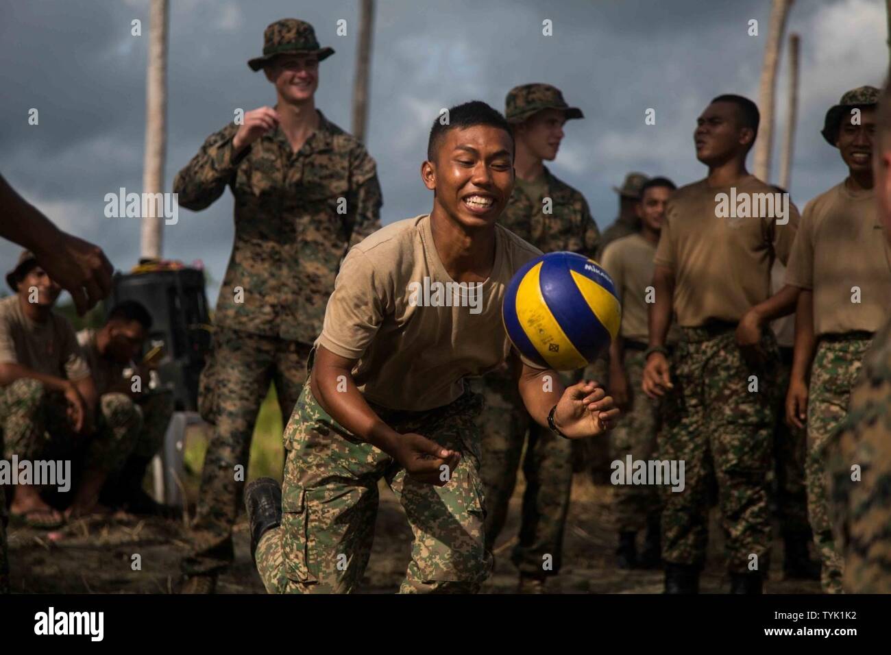 SABAH PROVINCE, Malaysia (November 12, 2016) A soldier with 7th Battalion, Royal Malay Regiment, prepares to serve during a volleyball game held alongside Marines with the 11th Marine Expeditionary Unit during Exercise Tiger Strike 2016, in Sabah Province, Malaysia, November 11, 2016. TS16 provided the U.S. and Malaysian service members the opportunity to strengthen military-to-military ties through joint training and troop-to-troop interactions. Stock Photo