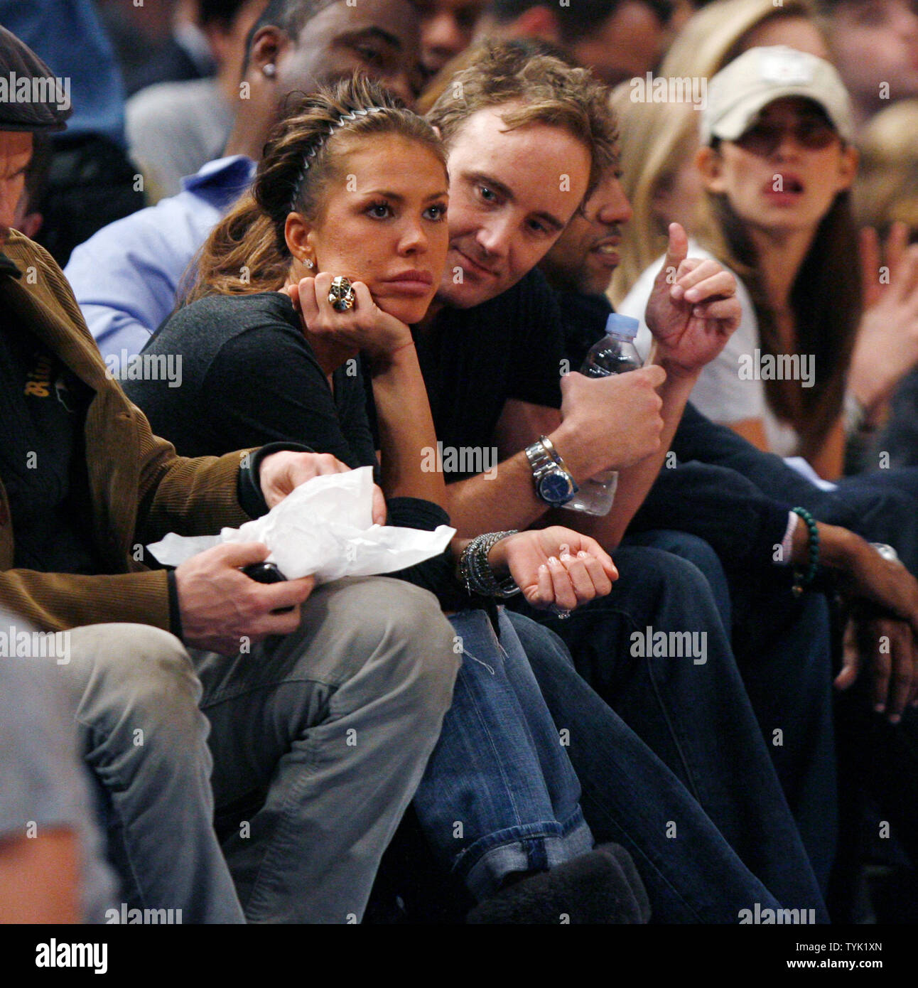 Nikki Cox and Jay Mohr (R) watch the New Jersey Nets play the New York Knicks at Madison Square Garden in New York City on March 18, 2009. The Nets defeated the Knicks 115-89.    (UPI Photo/John Angelillo) Stock Photo