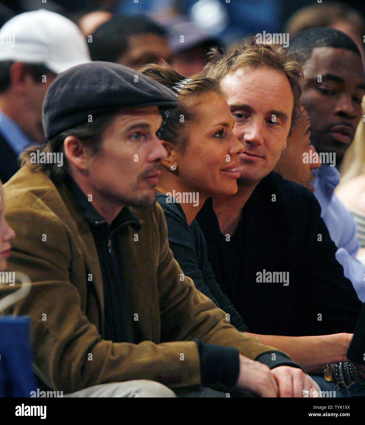 Ethan Hawke, Nikki Cox and Jay Mohr (R) watch the New Jersey Nets play the New York Knicks at Madison Square Garden in New York City on March 18, 2009. The Nets defeated the Knicks 115-89.    (UPI Photo/John Angelillo) Stock Photo