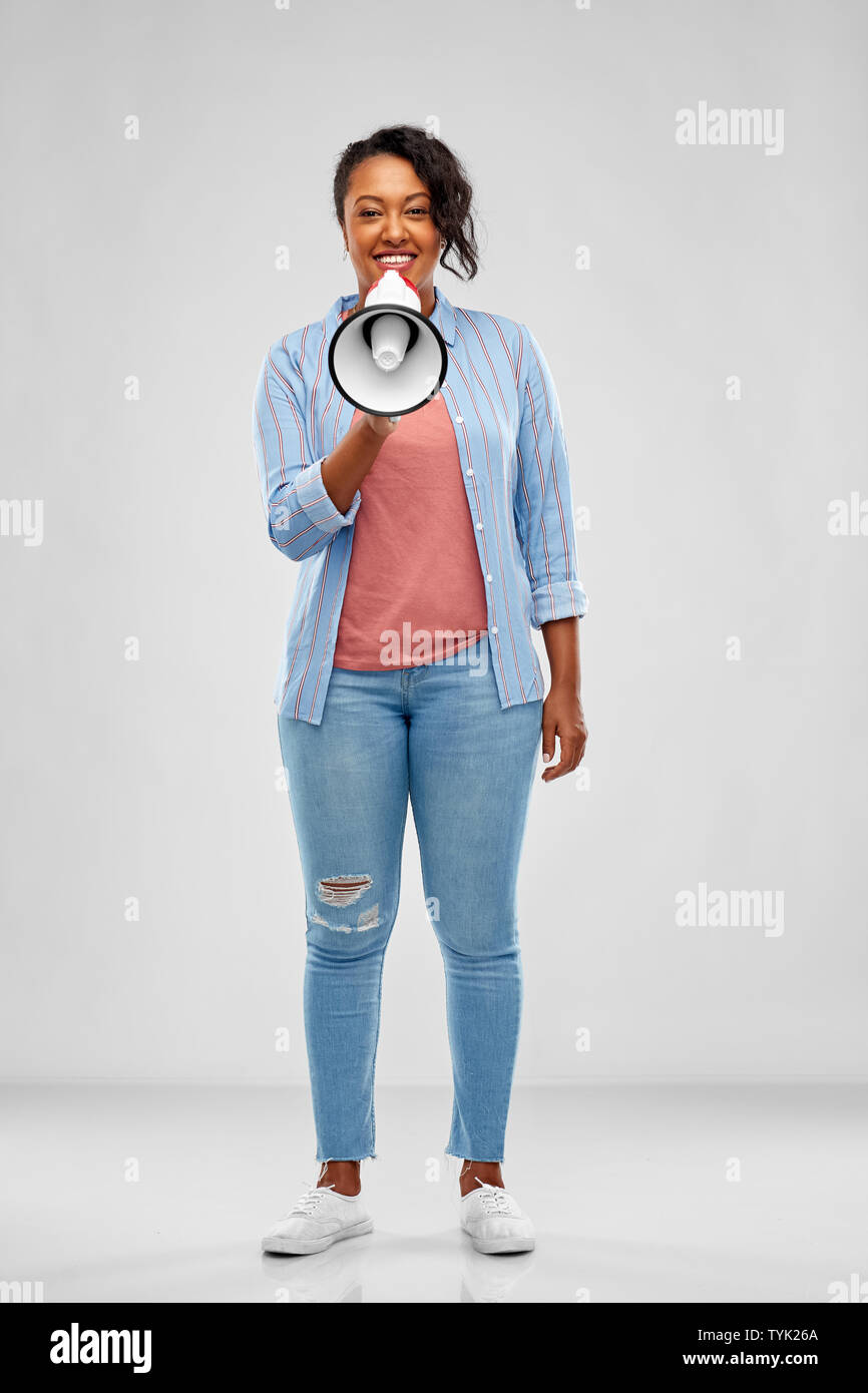 happy african american woman over grey background Stock Photo - Alamy