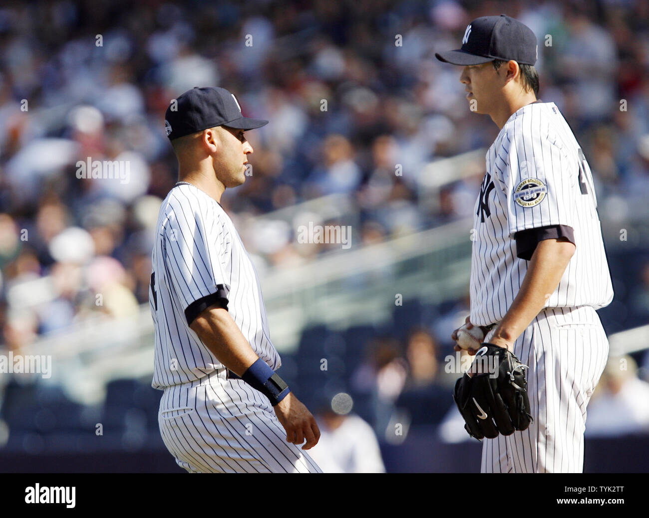 New York Yankees starting pitcher Chien-Ming Wang and Derek Jeter (L) talk  on the pitchers mound in the second inning against the Cleveland Indians at  Yankee Stadium in New York City on