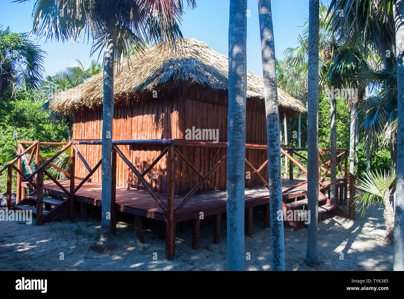 Closed beach bar hut made of palm trees on the white sand Stock Photo