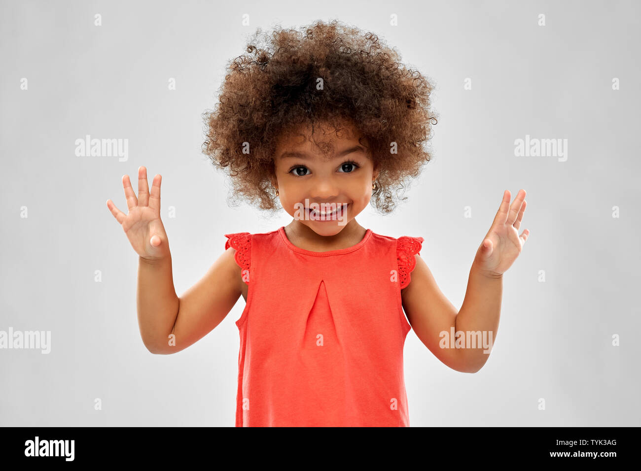 happy little african american girl over grey Stock Photo - Alamy