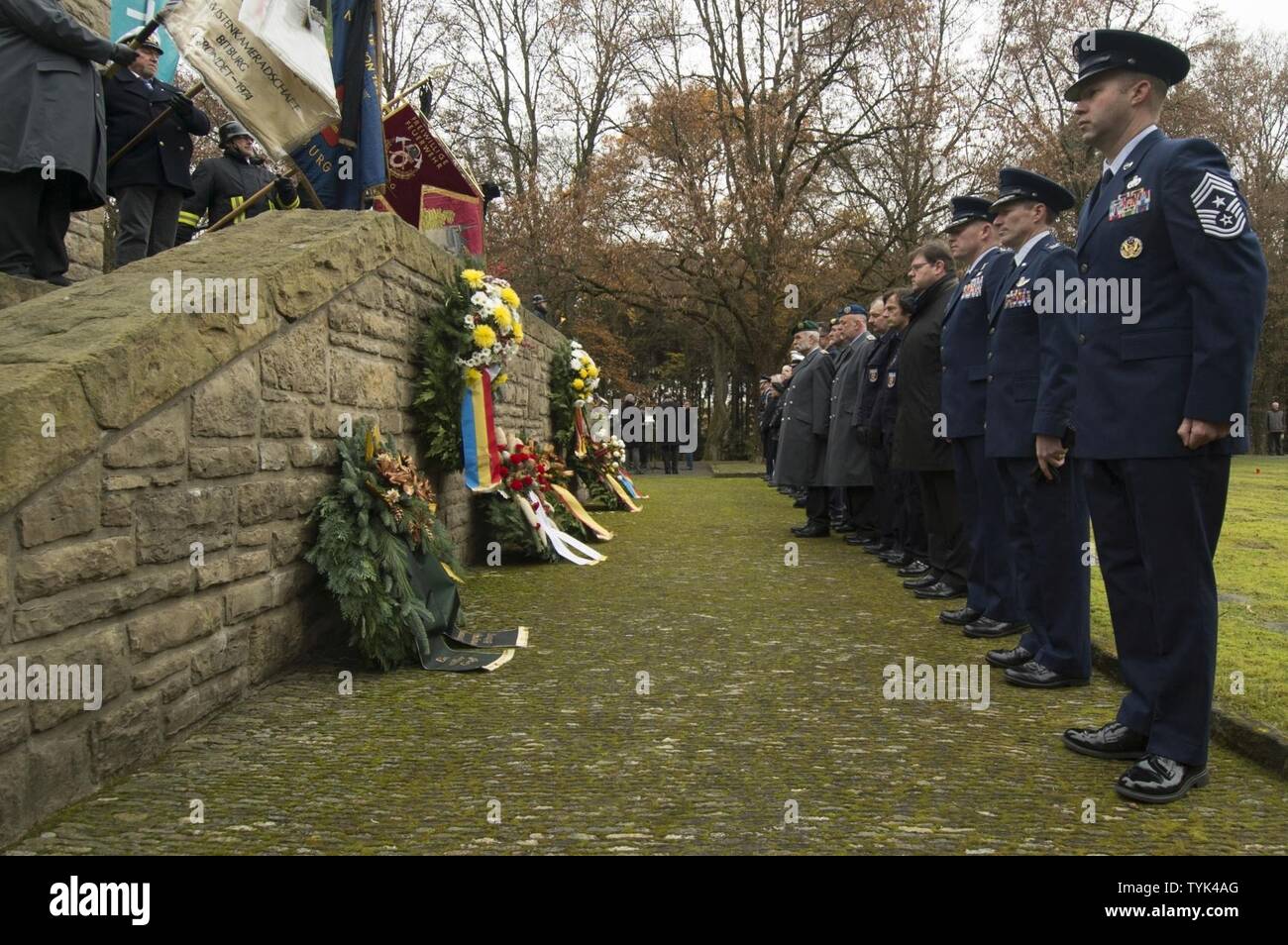 Leaders from the 52nd Fighter Wing, Spangdahlem Air Base, Germany, and  German citizens pause after presenting wreaths during a German National Day  of Mourning observance ceremony at the Kolmeshöhe Military Cemetery in