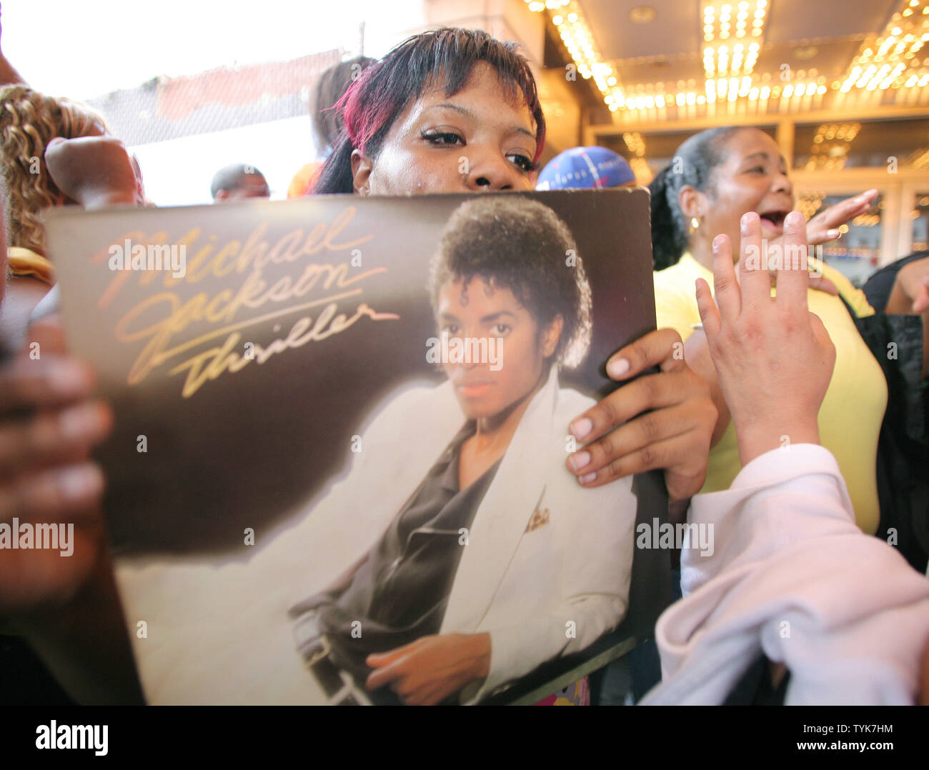 Shanaqua Donovich holds her copy of Michael Jackson's 'Thriller' album as fans gather at the Apollo to remember the pop singer on June 26, 2009 in New York. Jackson, who first performed at the theater at age 9, died the previous day from a heart attack. (UPI Photo/Monika Graff) Stock Photo