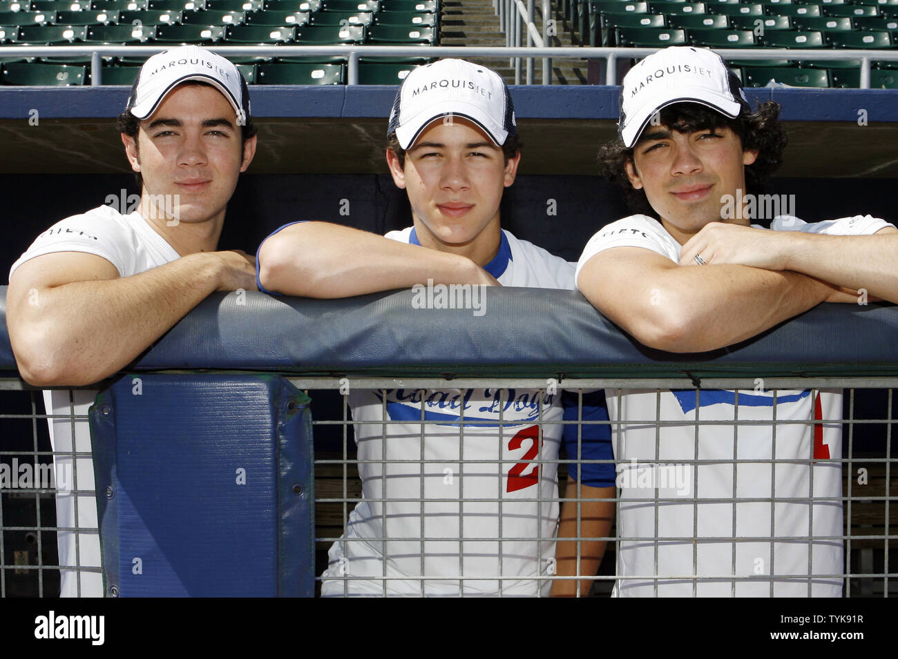 Kevin, Nick and Joe Jonas of the Jonas Brothers stand in the dug out before a game of softball against a team of Marquis Jet and NetJets players at Newark Bears Stadium in Newark, New Jersey on July 15, 2009.       (UPI Photo/John Angelillo) Stock Photo