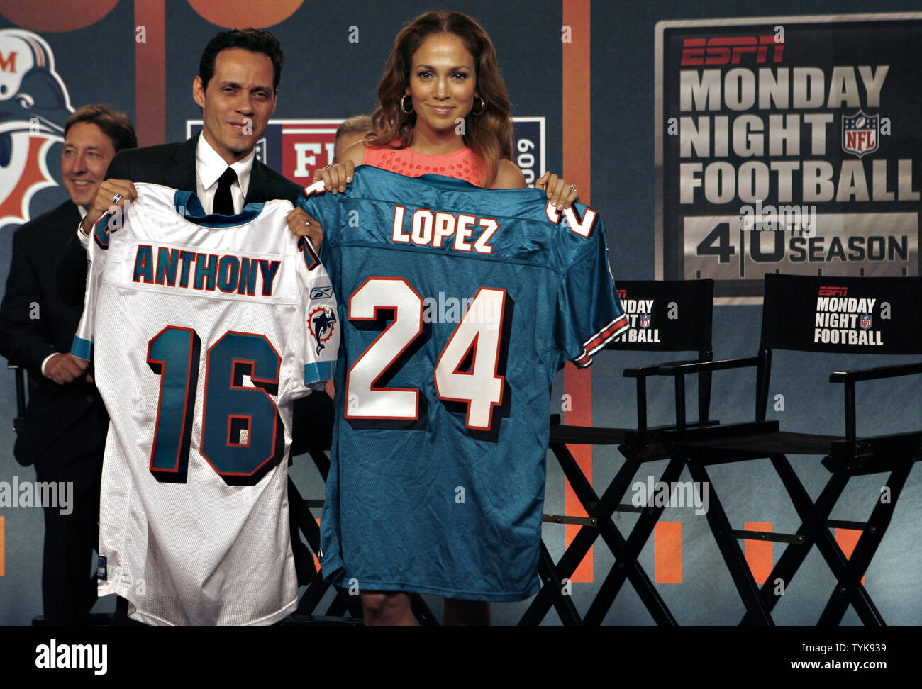 Jennifer Lopez and Marc Anthony hold up Miami Dolphins Jerseys on the stage  at the NFL, ESPN/ESPN Deportes and the Miami Dolphins press conference to  announce Marc Anthony as part owner of