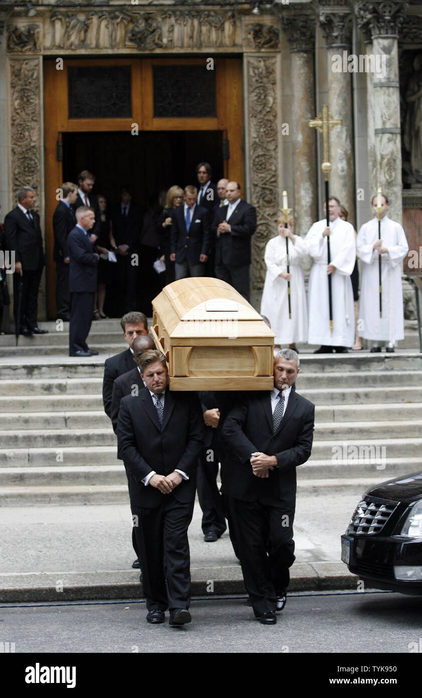 Pallbearers carry the casket of celebrated CBS newsman Walter Cronkite