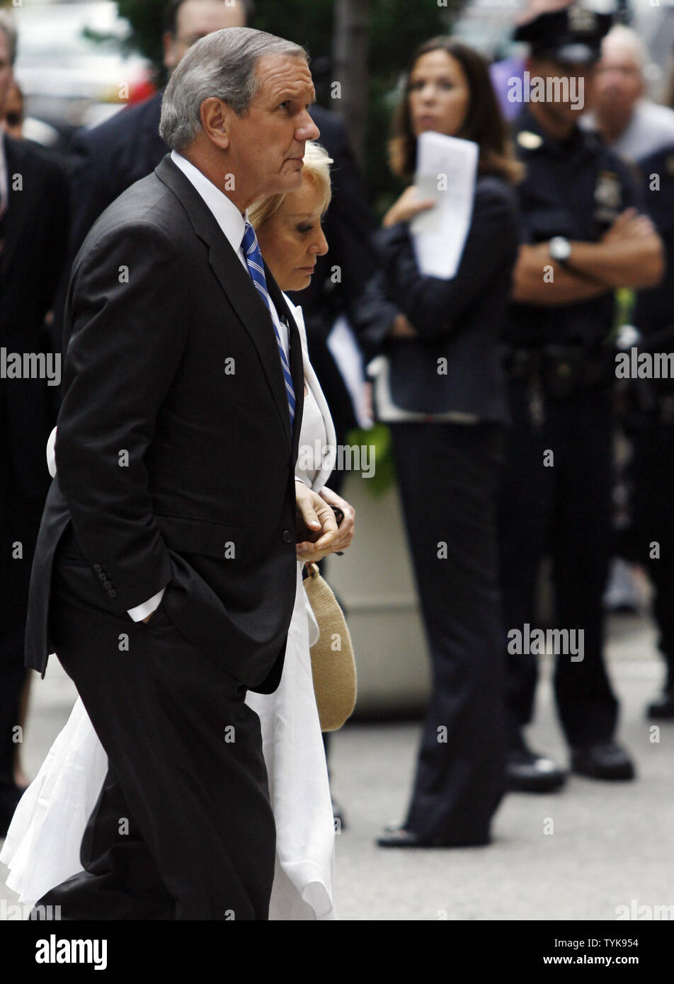 Charles Gibson and Barbara Walters walk into the funeral of celebrated