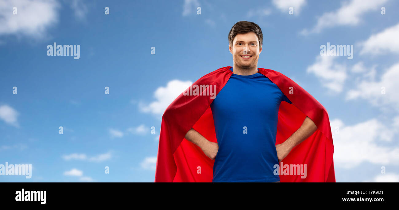 man in red superhero cape over sky background Stock Photo - Alamy