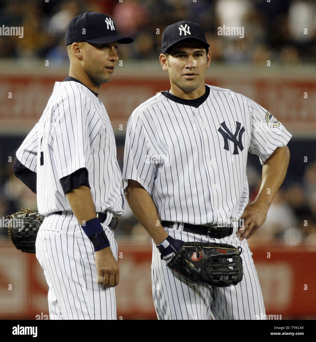 New York Yankees Derek Jeter and Johnny Damon stand in the infield