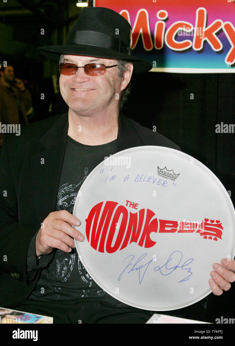 Micky Dolenz of the rock band The Monkees holds up an autographed drum