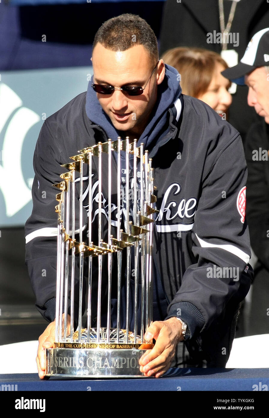 Derek Jeter of the New York Yankees sets down the World Series trophy as  the Yankees are honored and given keys to the city at City Hall following a  ticker tape parade