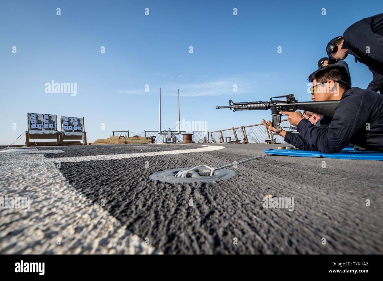 SEA OF JAPAN (Nov. 14, 2016) Petty Officer 3rd Class Eric Nieto loads a magazine into an M16 rifle aboard the forward-deployed Arleigh Burke-class guided-missile destroyer USS Barry (DDG 52) during small arms qualification training. Barry is on patrol in the U.S. 7th Fleet area of operations supporting security and stability in the Indo-Asia-Pacific region. Stock Photo