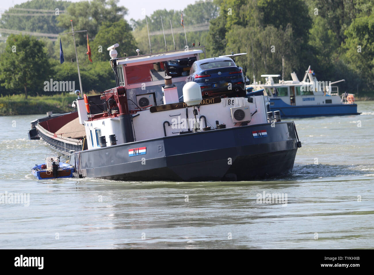 26 June 2019, Baden-Wuerttemberg, Karlsruhe: A cargo ship is stuck on the Rhine. Due to the shipwreck the descent on the Rhine has been closed. (The registration numbers of the vehicle and the ship were made illegible for the protection of personal rights.) Photo: Thomas Riedel/dpa Stock Photo