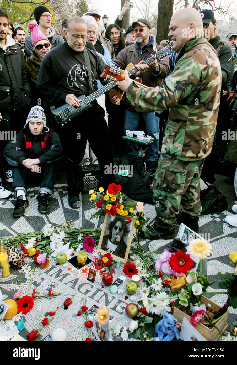 A band performs Beatles songs as John Lennon fans gather at Strawberry