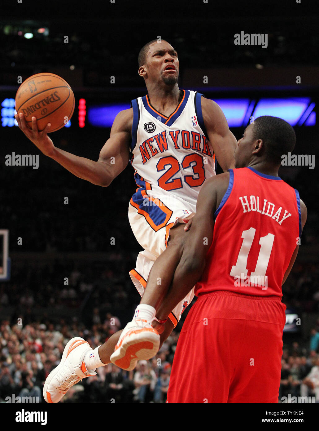 New York Knicks Toney Douglas drives by Philadelphia 76ers Jrue ...
