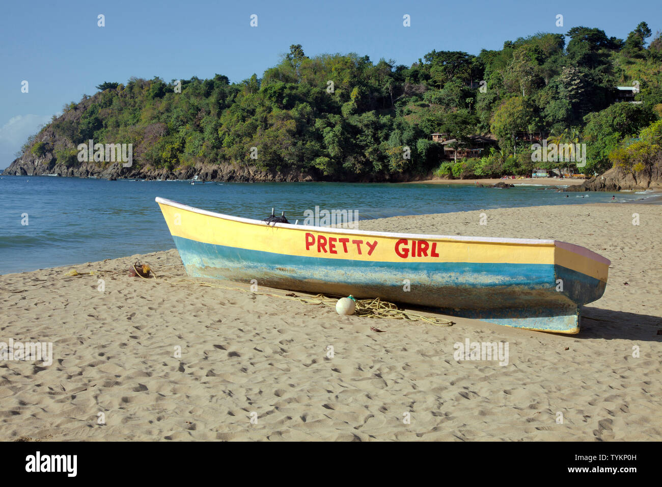 'Pretty Girl' boat rests on the beach at Castara Bay, Tobago. Stock Photo