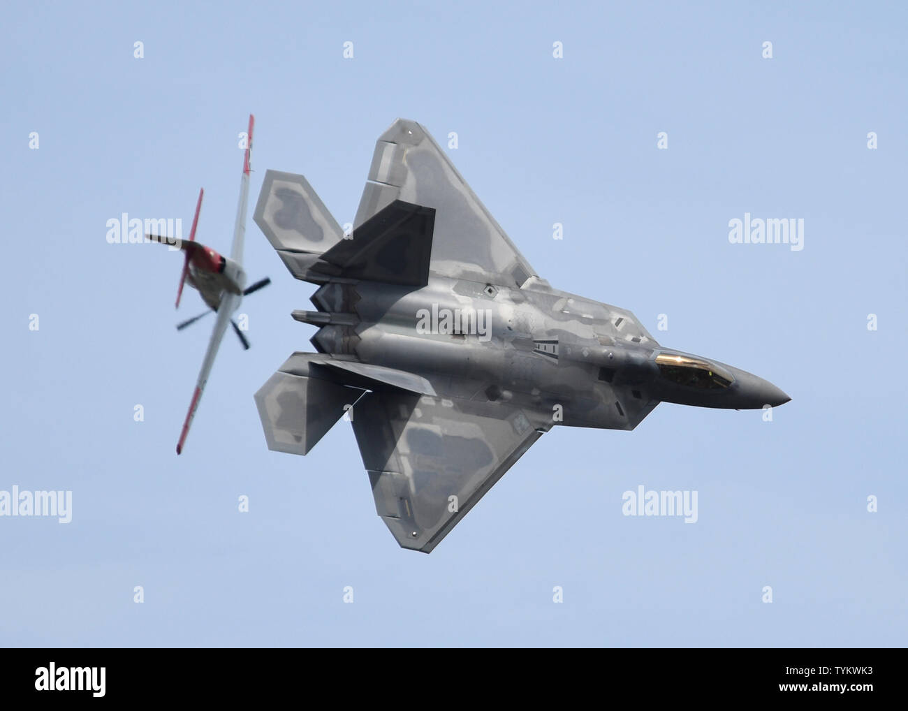 An F22 Raptor and a P51 Mustang perform a Heritage Flight during the