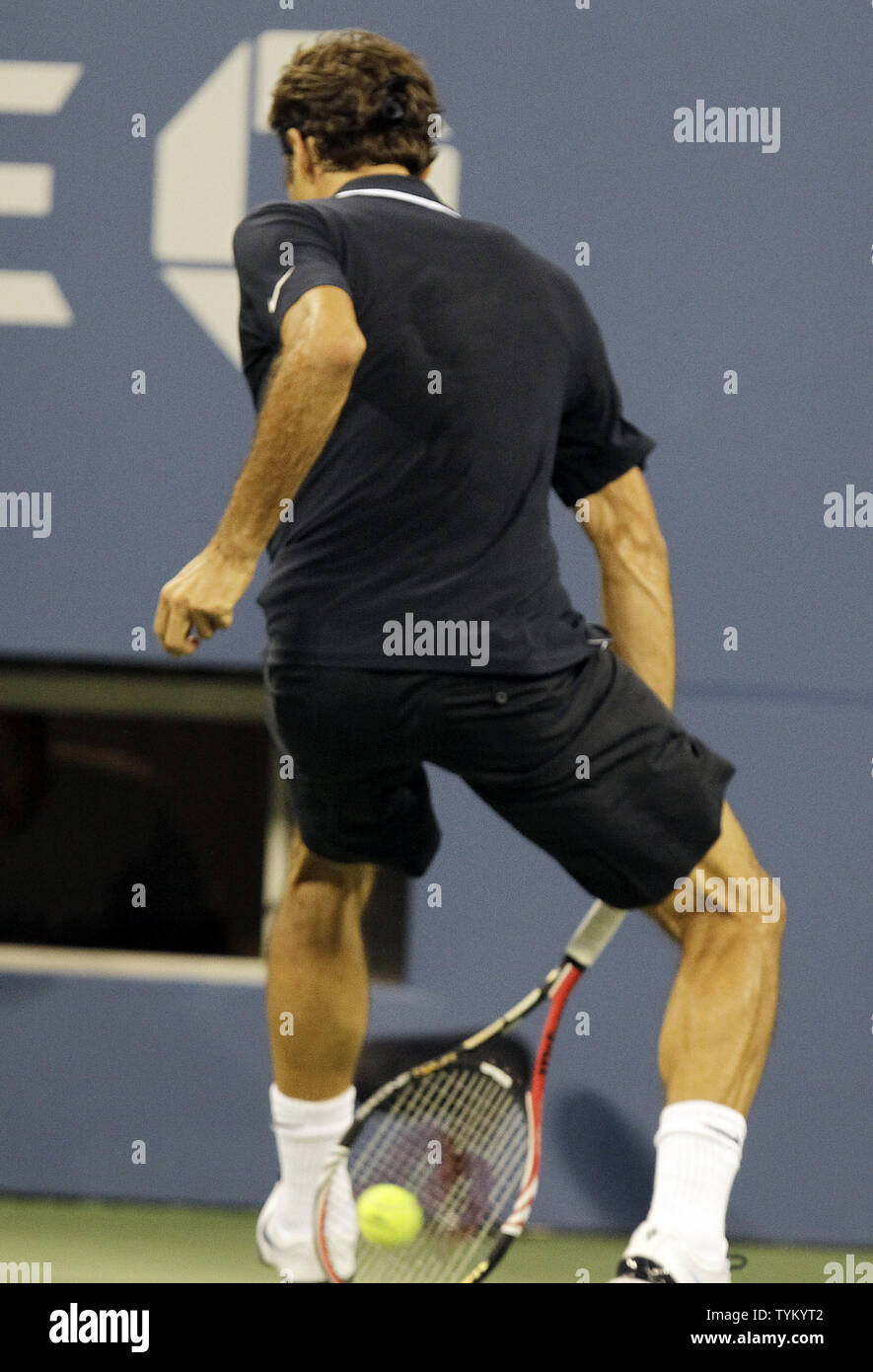 Roger Federer of the USA hits a ball between his legs and wins the point in  the second set against Brian Dabul of Argentina in the first round of the  U.S. Open
