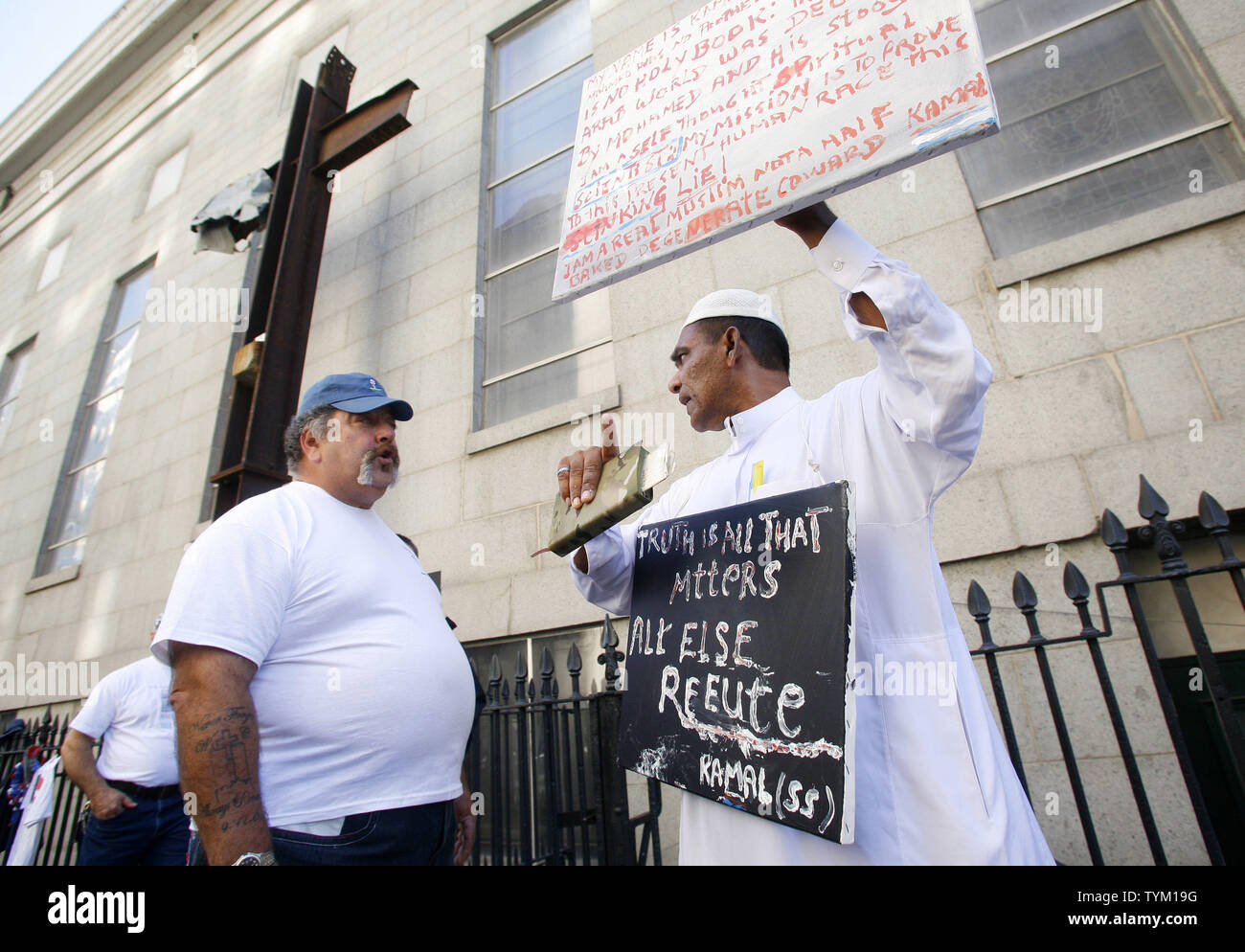 Frank Silecchai (L) of Rock Hill, SC, and Kamal Ramdass, of New York, who  is Muslim, both discuss their opposition to the "Ground Zero" mosque on  September 11, 2010 in New York