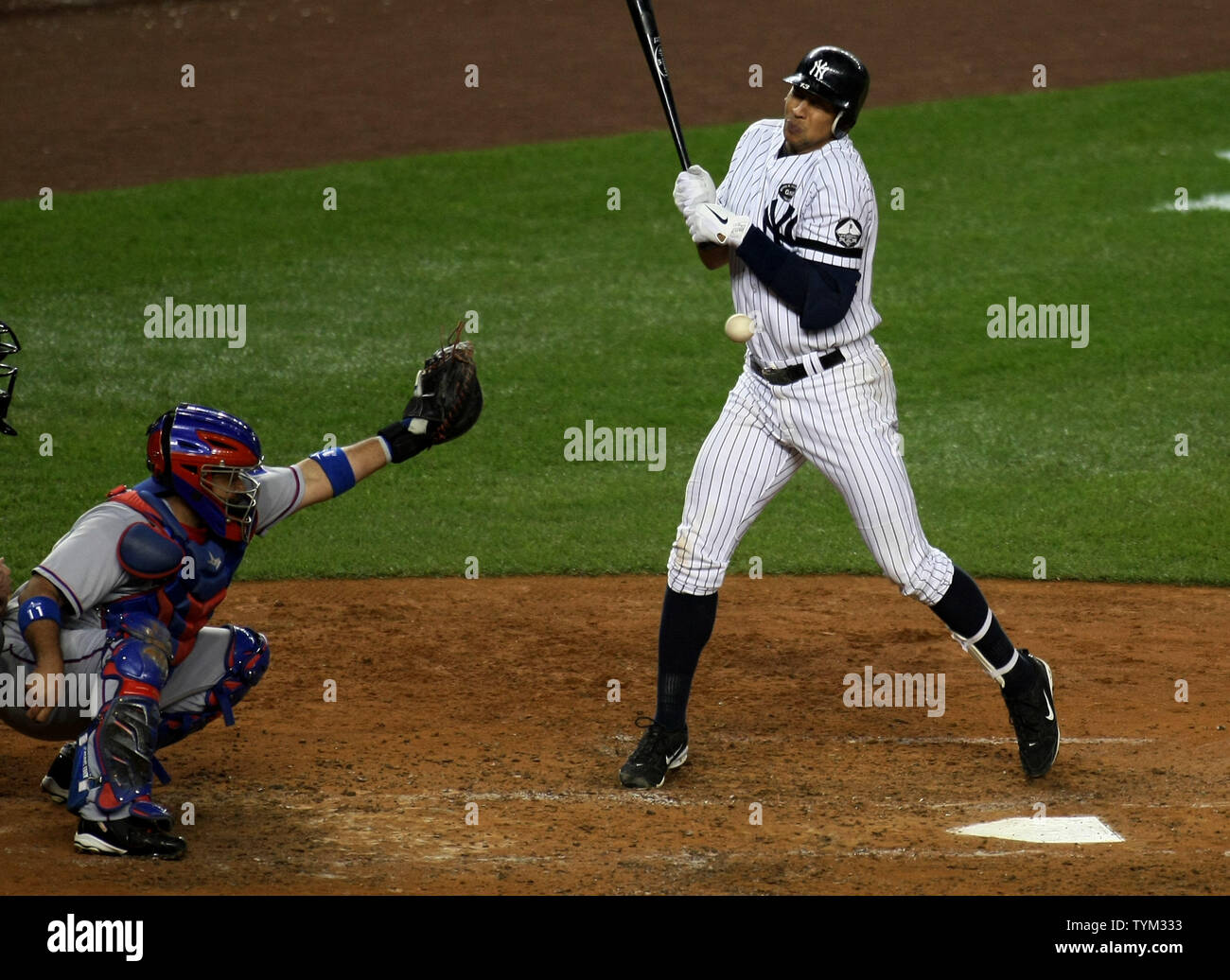 Alex Rodriguez of the New York Yankees is hit by a pitch as Bengie Molina catches for theTexas Rangers in the fourth inning during game four of the ALCS at Yankee Stadium