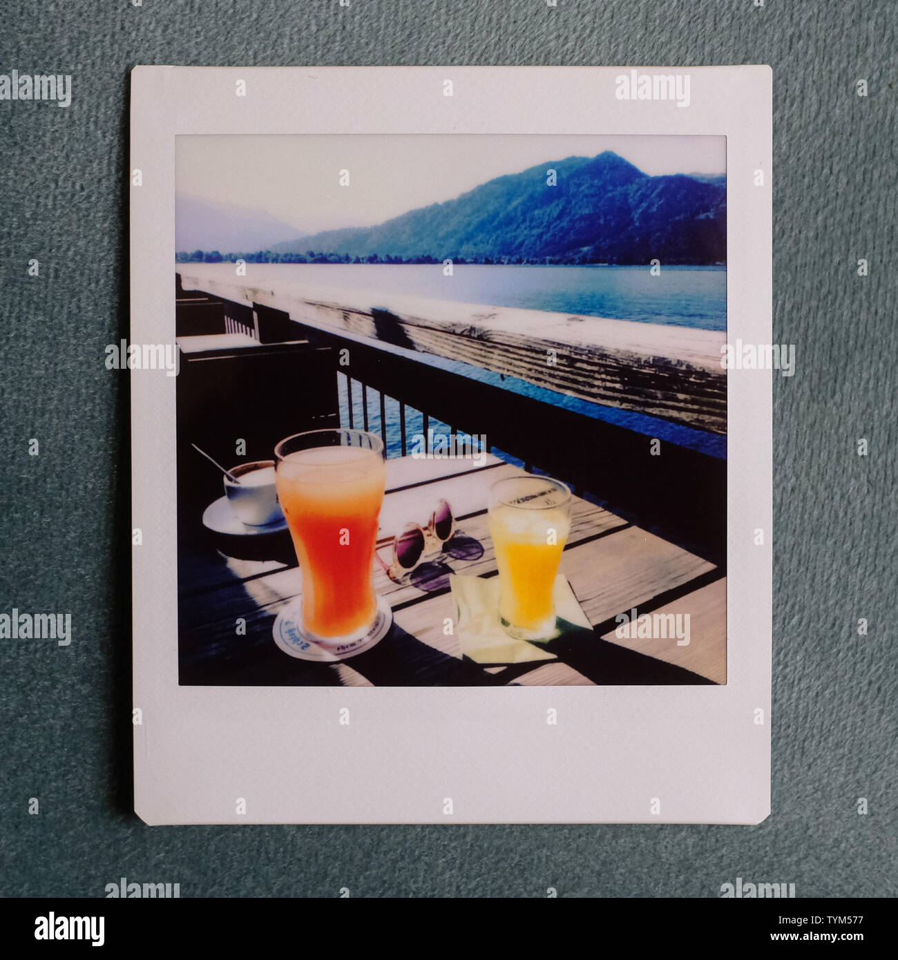 polaroid of a table with fresh drinks and seaview during spring/summer Stock Photo