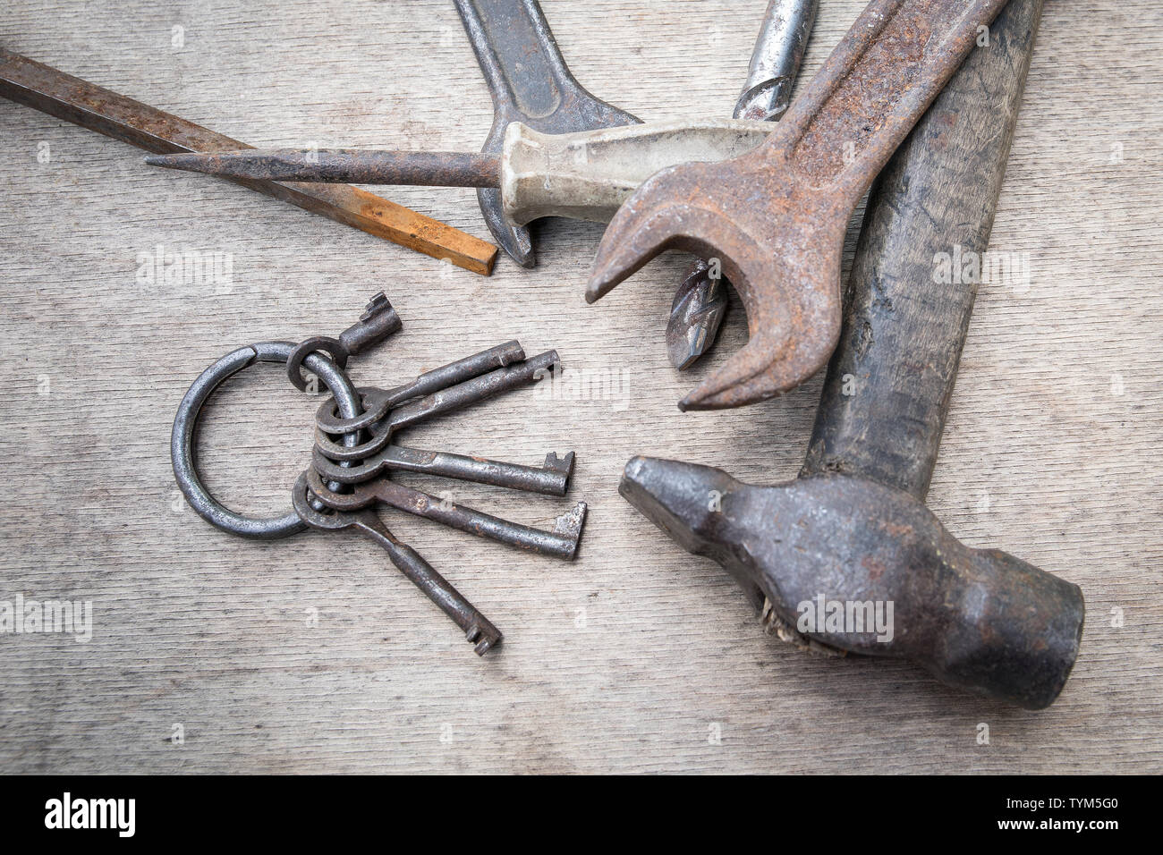 Bunch of different keys and hand tools on wooden board, maintenance and reparing concept Stock Photo