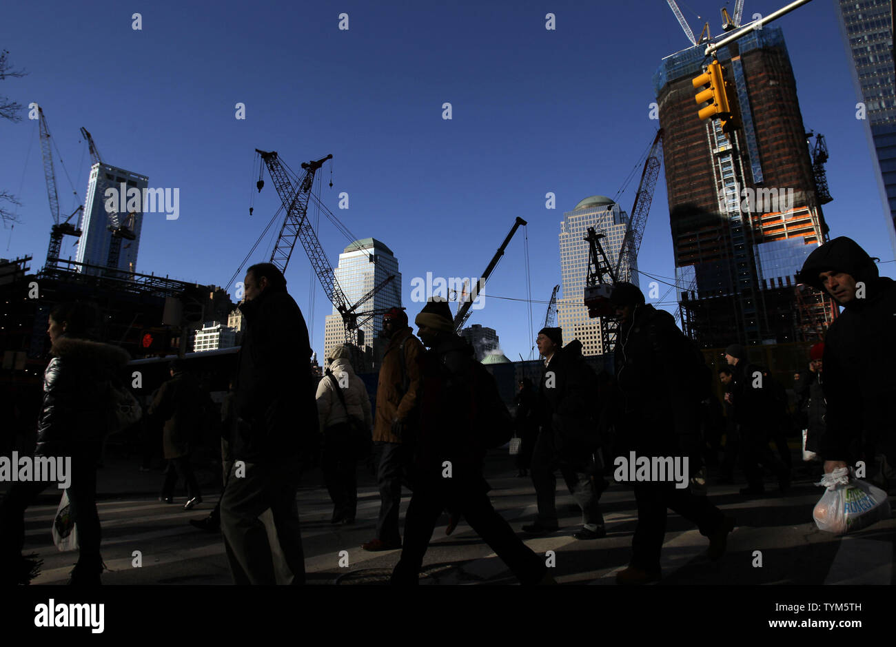 People cross at an intersection near Ground Zero, the site of the former Twin Towers, nine and 1/2 years after the terrorist attacks on the World Trade Center in New York on January 3, 2011.   UPI/John Angelillo Stock Photo