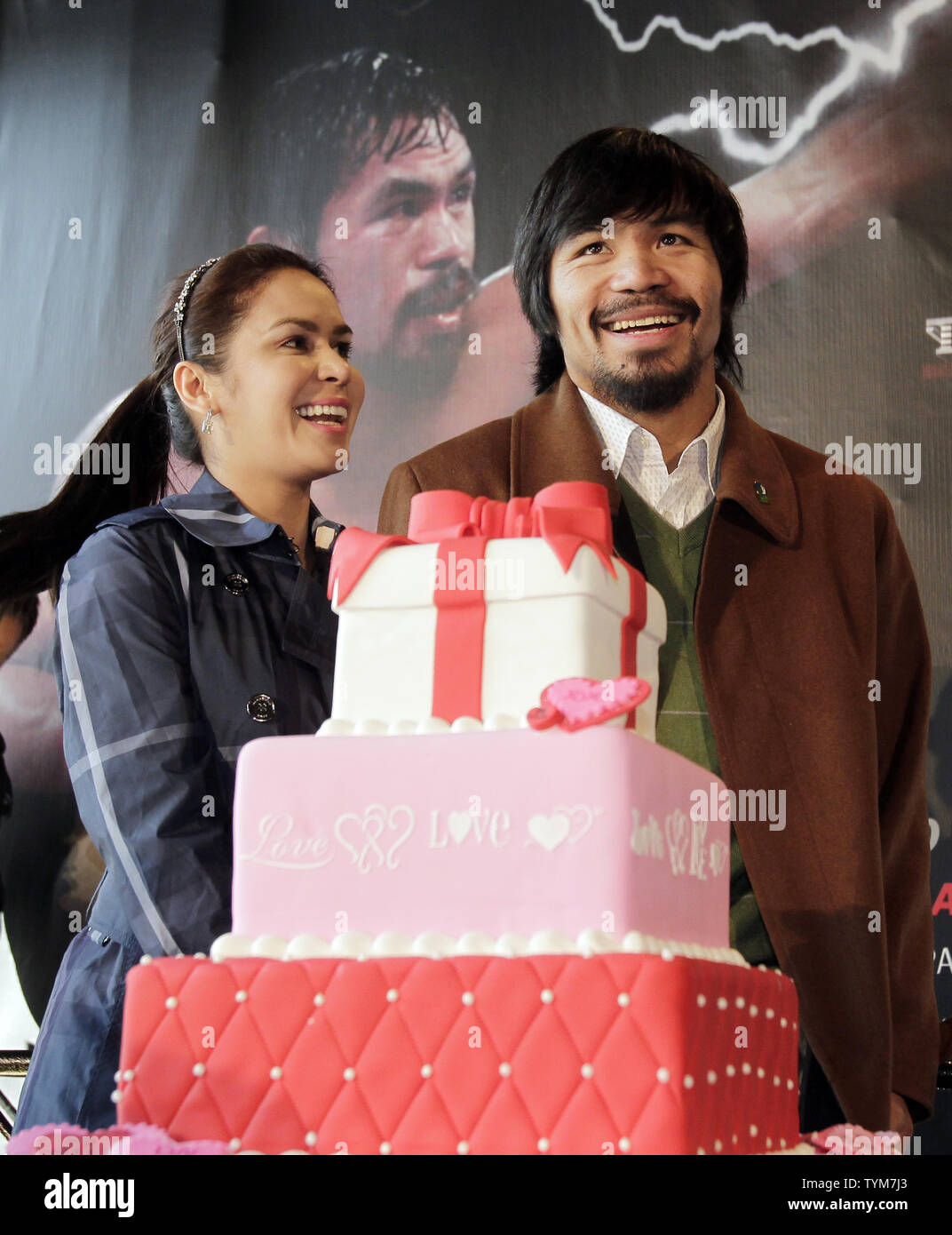 Manny and Jinkee Pacquiao stand next to a Valentines Day cake at a press conference to promote the upcoming fight between Manny Pacquiao and Shane Mosley at the MGM Grand in Las Vegas at Chelsea Piers on Valentines Day in New York City on February 14, 2011.       UPI/John Angelillo Stock Photo