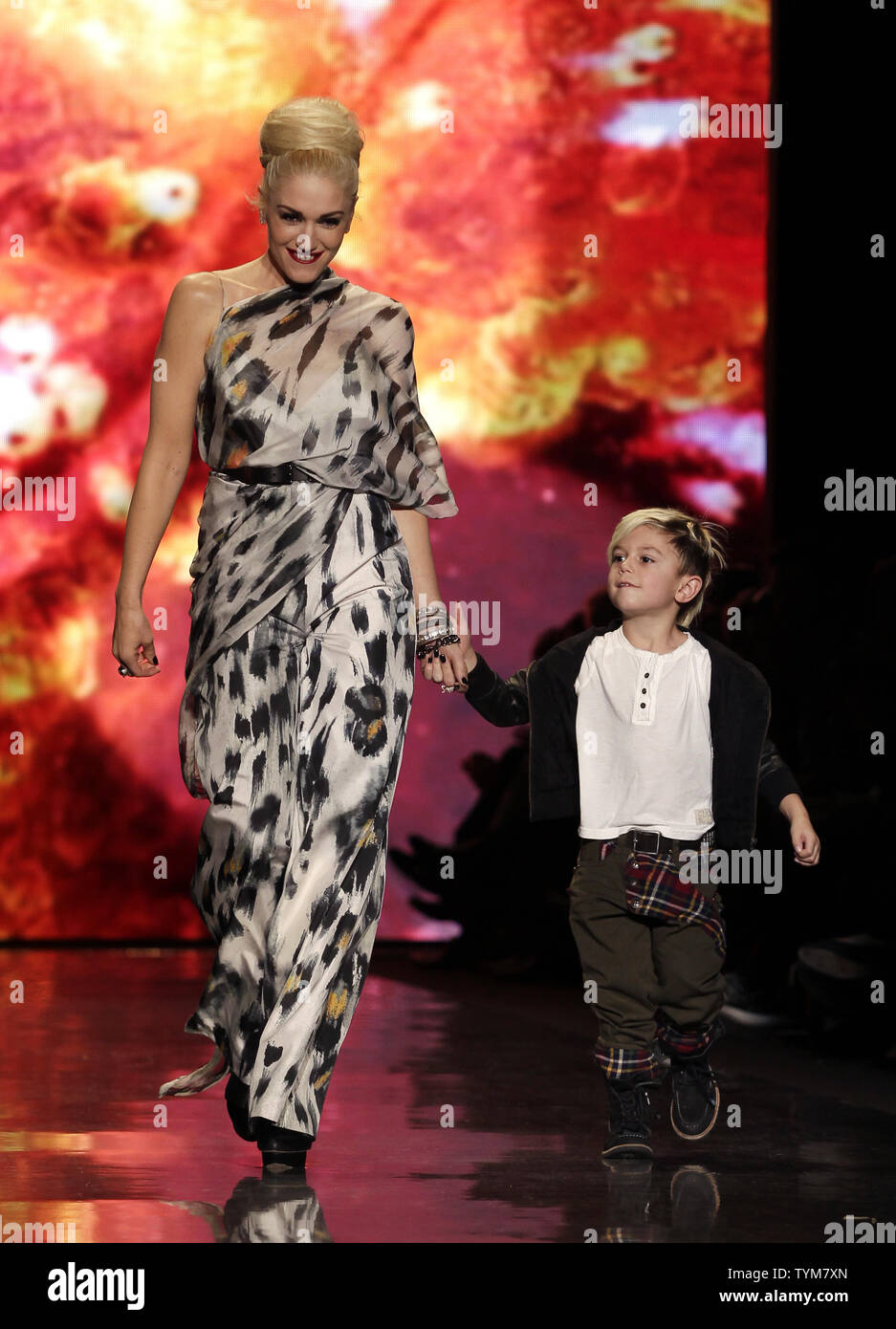 Gwen Stefani and her son Kingston Rossdale walk on the runway after the