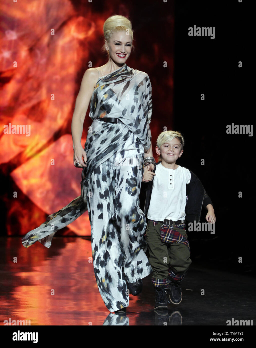 Gwen Stefani and her son Kingston Rossdale walk on the runway after the