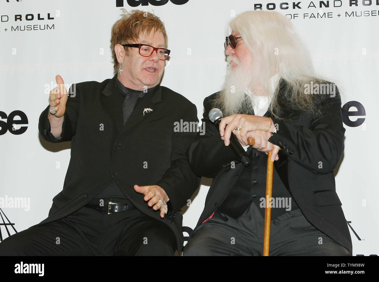 Elton John (L) talks with inductee Leon Russell at the Rock and Roll Hall of Fame induction ceremony held at the Waldorf-Astoria hotel in New York on March 14, 2011.      UPI Photo/Monika Graff... Stock Photo