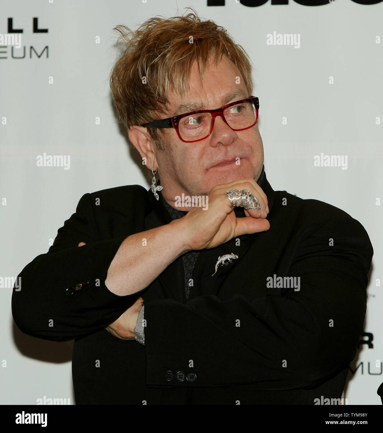 Elton John listens to reporters at the Rock and Roll Hall of Fame induction ceremony where he will introduce inductee Leon Russell at the Waldorf-Astoria hotel in New York on March 14, 2011.      UPI Photo/Monika Graff... Stock Photo