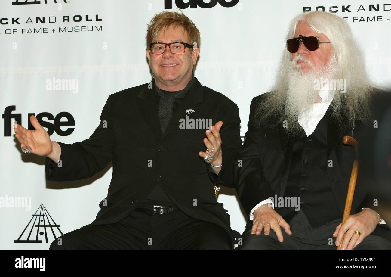 Elton John talks to reporters at the Rock and Roll Hall of Fame induction ceremony where he will introduce inductee Leon Russell, right, at the Waldorf-Astoria hotel in New York on March 14, 2011.      UPI Photo/Monika Graff... Stock Photo
