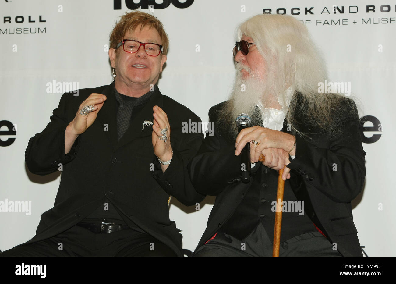 Elton John (L) answers reporters' questions as inductee Leon Russell at the Rock and Roll Hall of Fame induction ceremony held at the Waldorf-Astoria hotel in New York on March 14, 2011.      UPI Photo/Monika Graff... Stock Photo