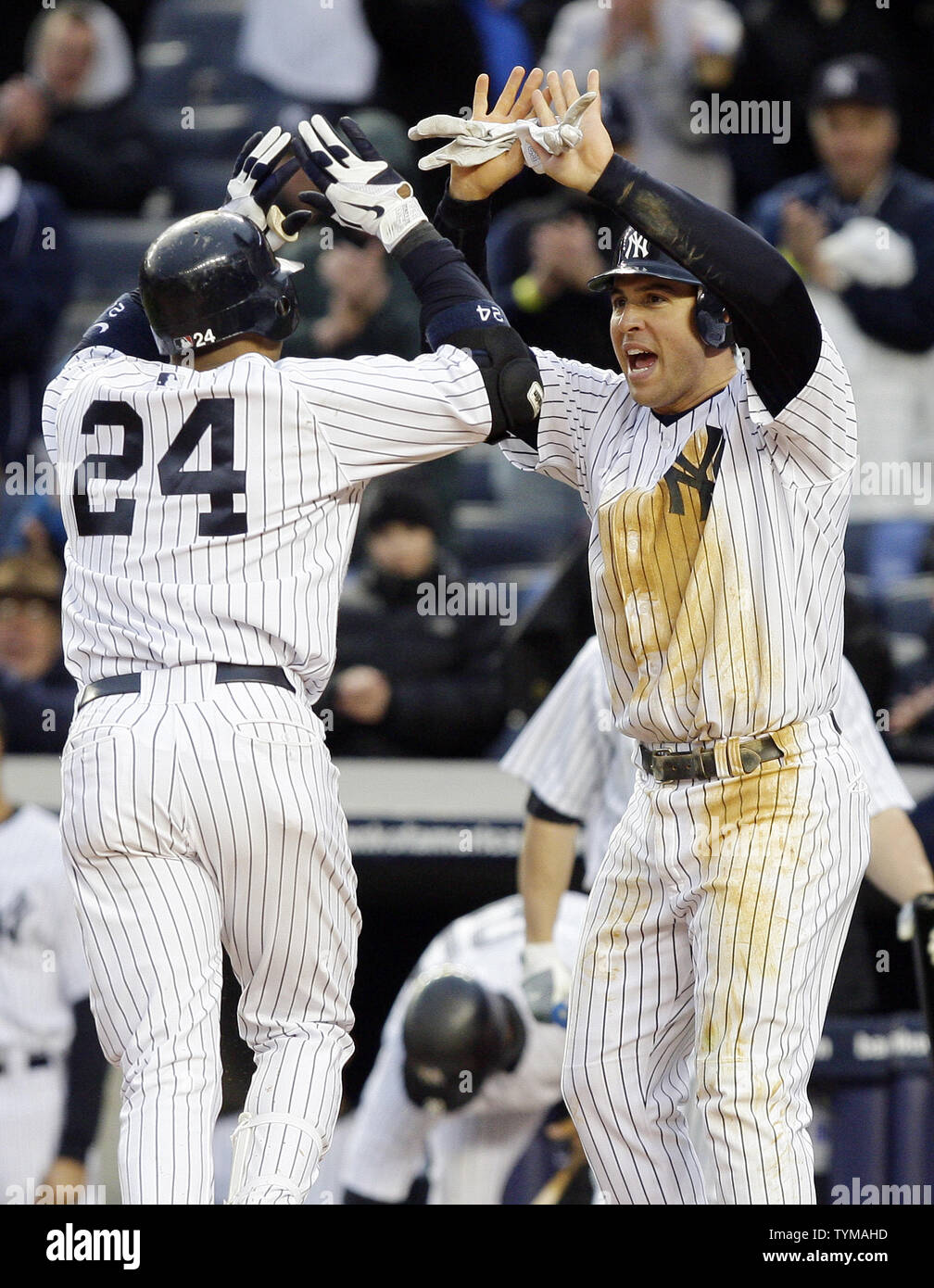New York Yankees Robinson Cano and Mark Teixeira react at home plate after Cano hits a 2-run homer in the eighth inning against the Texas Rangers at Yankee Stadium in New York City on April 16, 2011.       UPI/John Angelillo Stock Photo