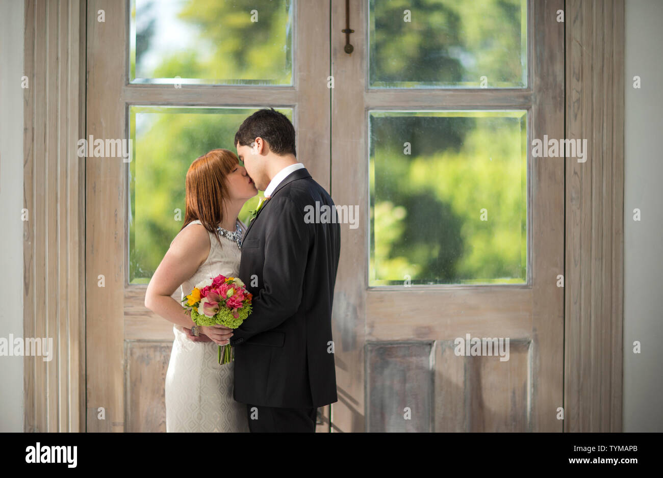 Bride and groom kissing at their wedding Stock Photo - Alamy