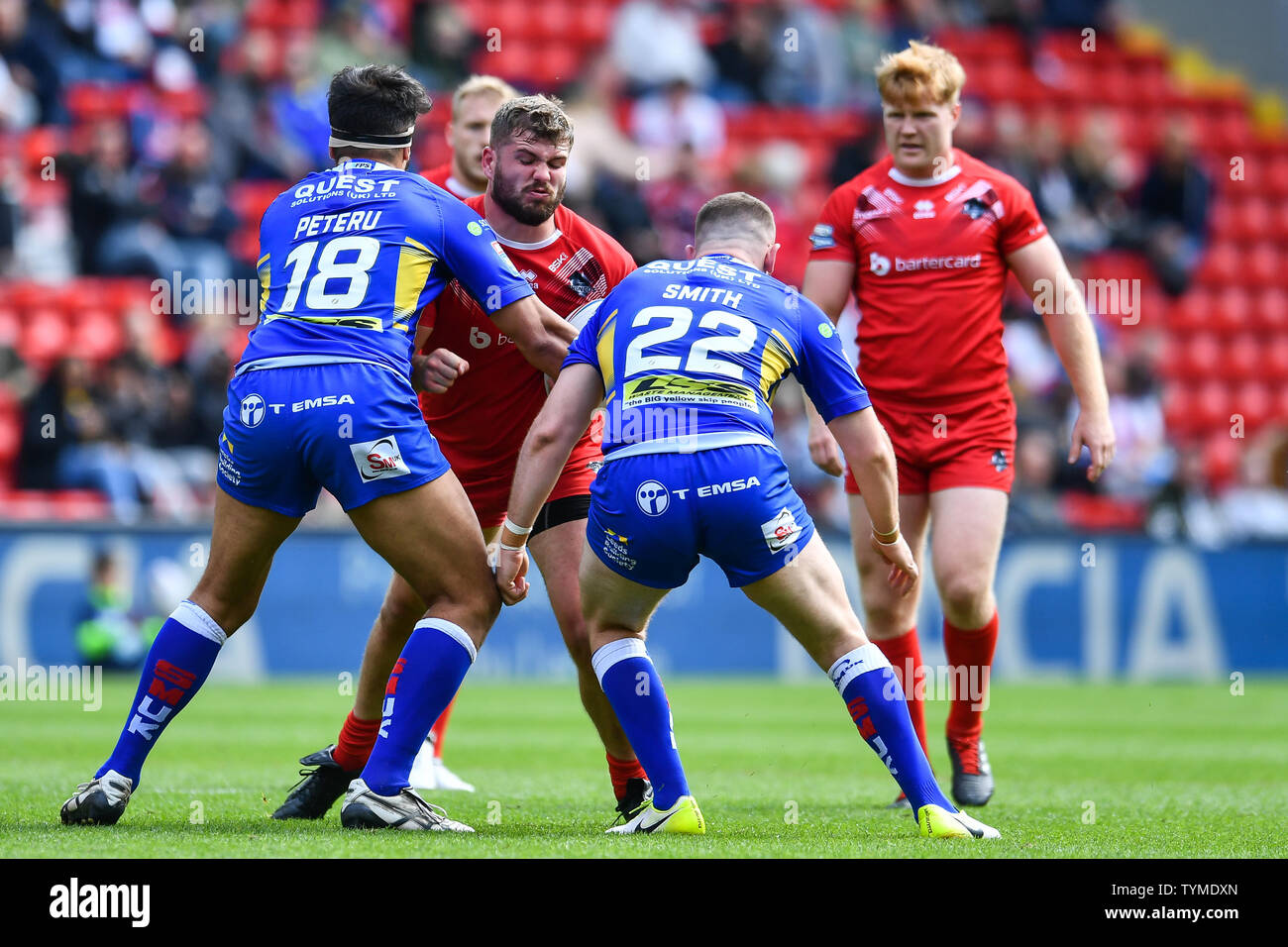 26th May 2019 , Anfield Stadium, Liverpool, England; Dacia Magic Weekend, Betfred Super League Round 16, Leeds Rhinos vs London Broncos ; Robert Butler (23) of London Broncos is tackled by Nathaniel Peteru (18) of Leeds Rhinos  Credit: Craig Thomas/News Images Stock Photo