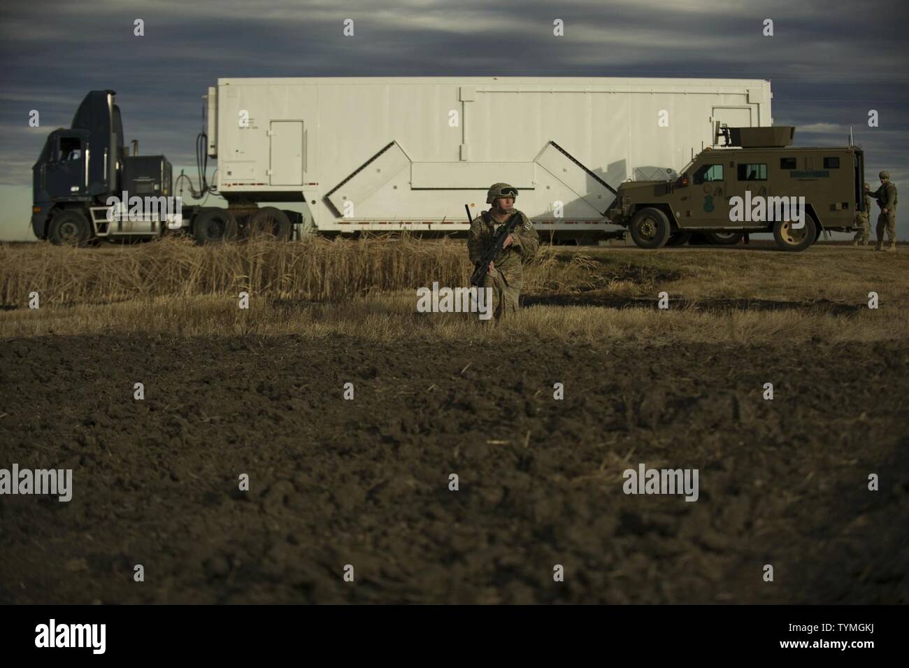 An Airman from the 791st Missile Security Forces Squadron provides security during a recapture and recovery exercise at the missile complex, N.D., Nov. 16, 2016. During the simulated scenario, defenders set up a security perimeter to watch for hostile forces. Stock Photo