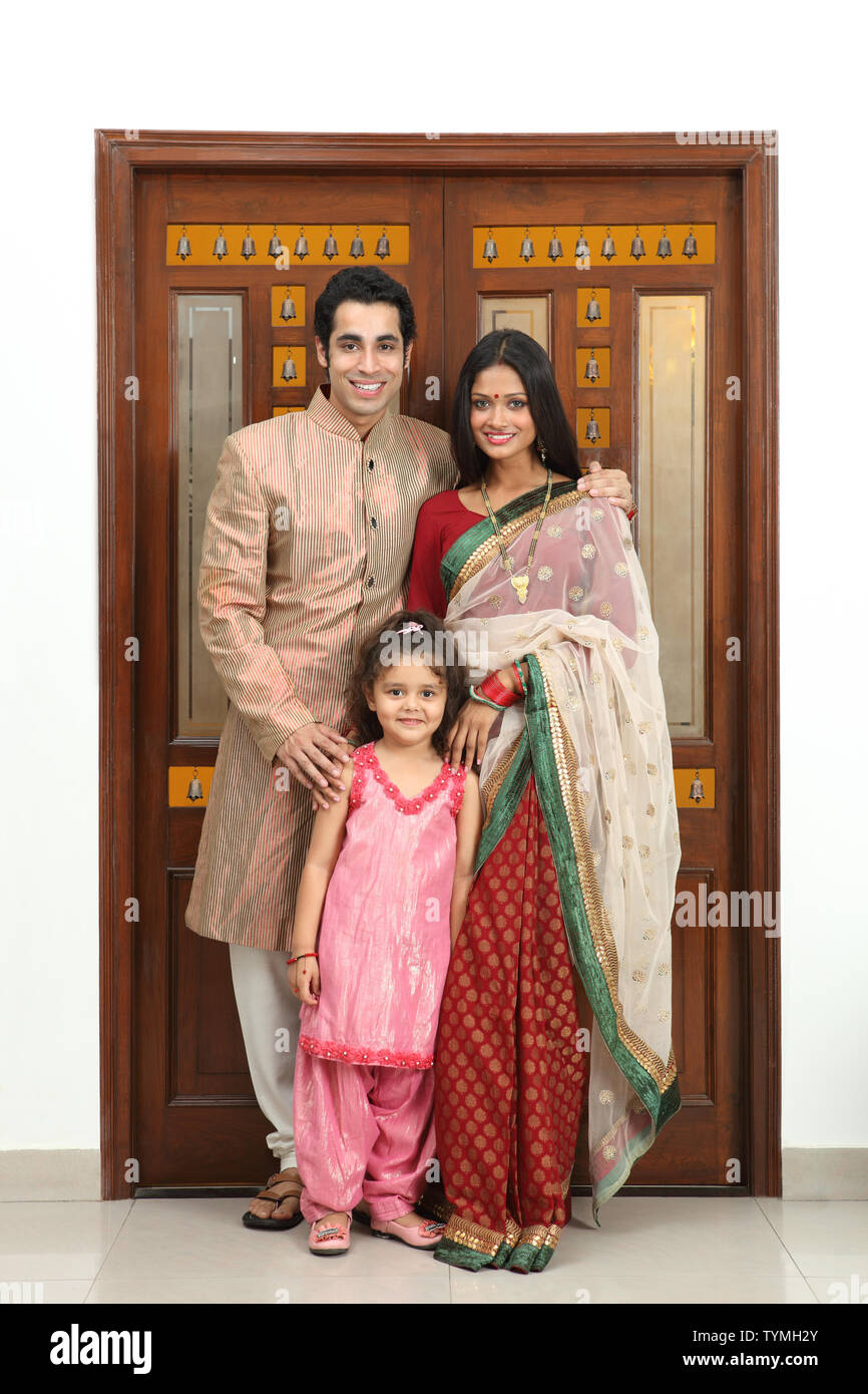 Family standing in front of a door Stock Photo - Alamy